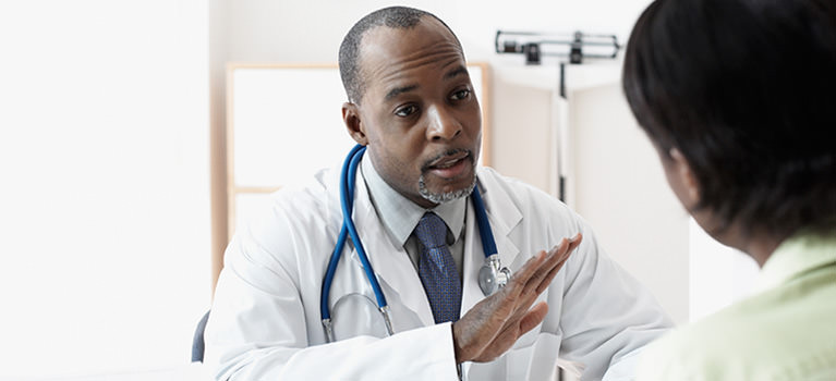 doctor speaking with a patient in his office